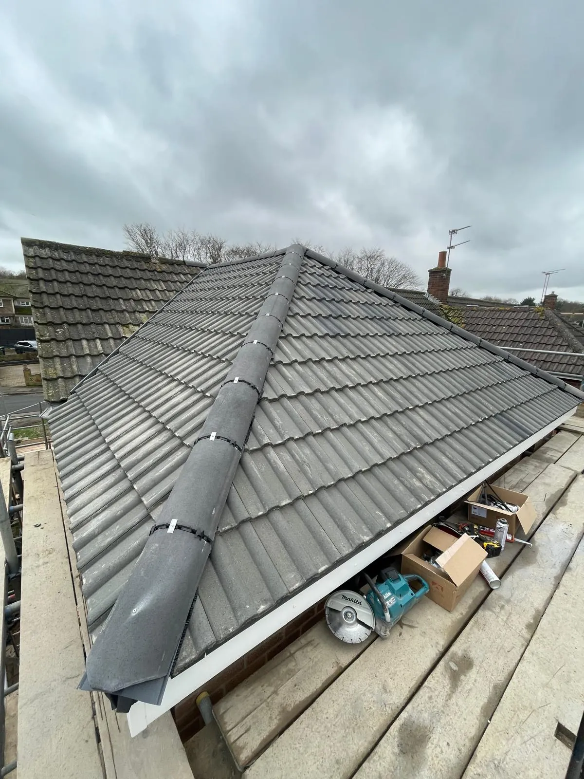 Finished hipped roof in grey interlocking tiles