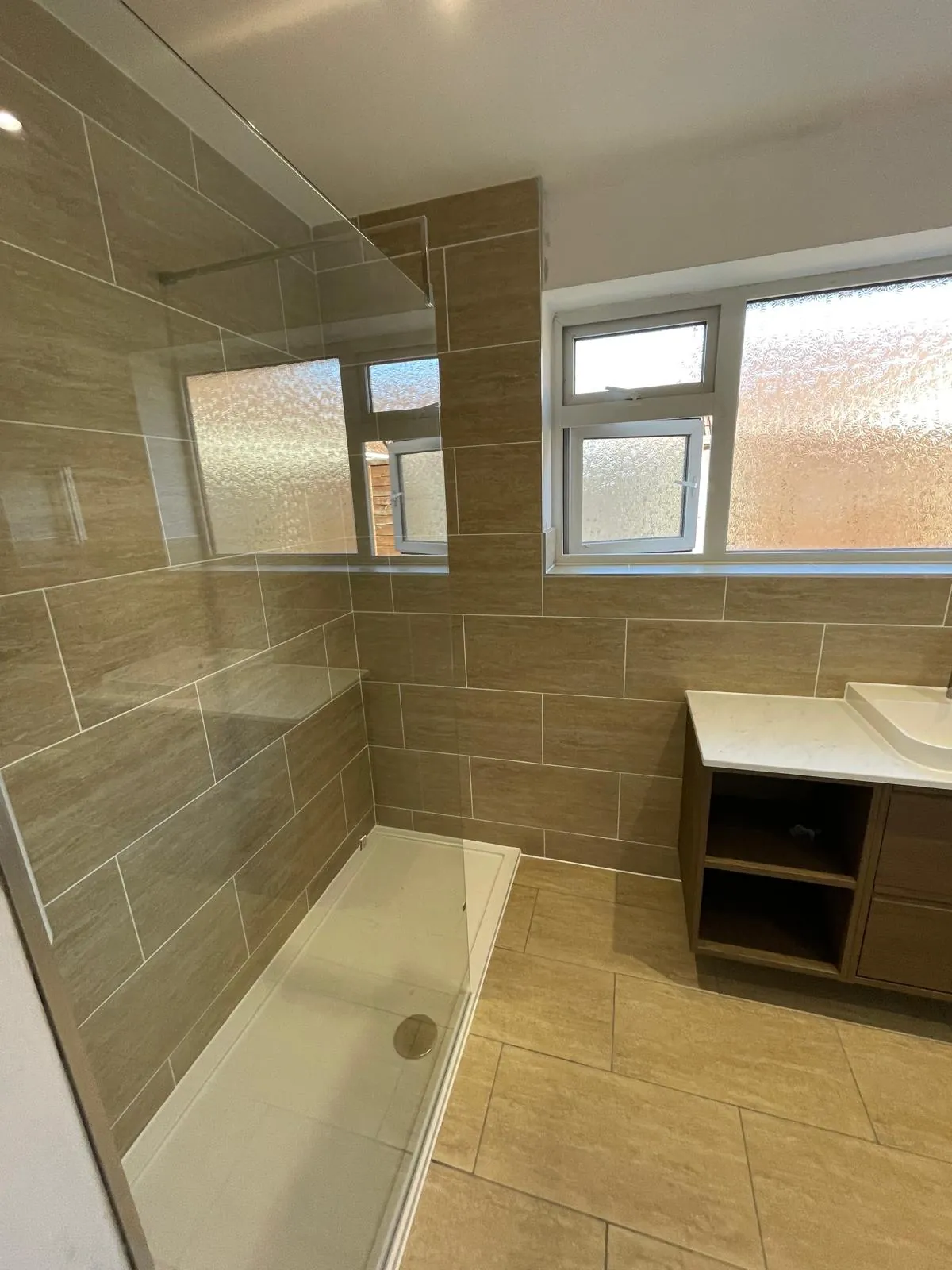 New shower room with a low-profile tray and full-height tiling