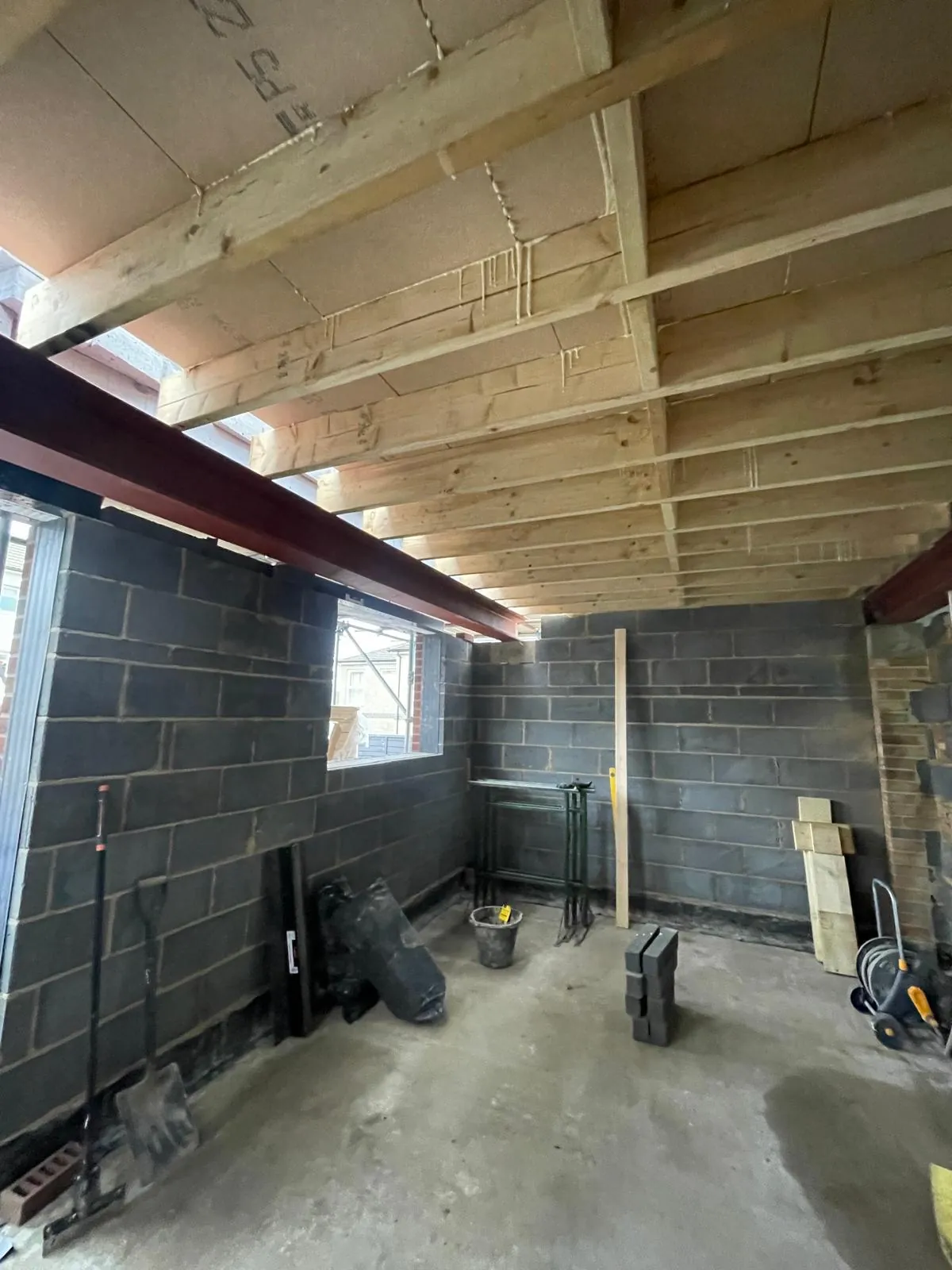 Steel beam and new timber joists inside an extension shell